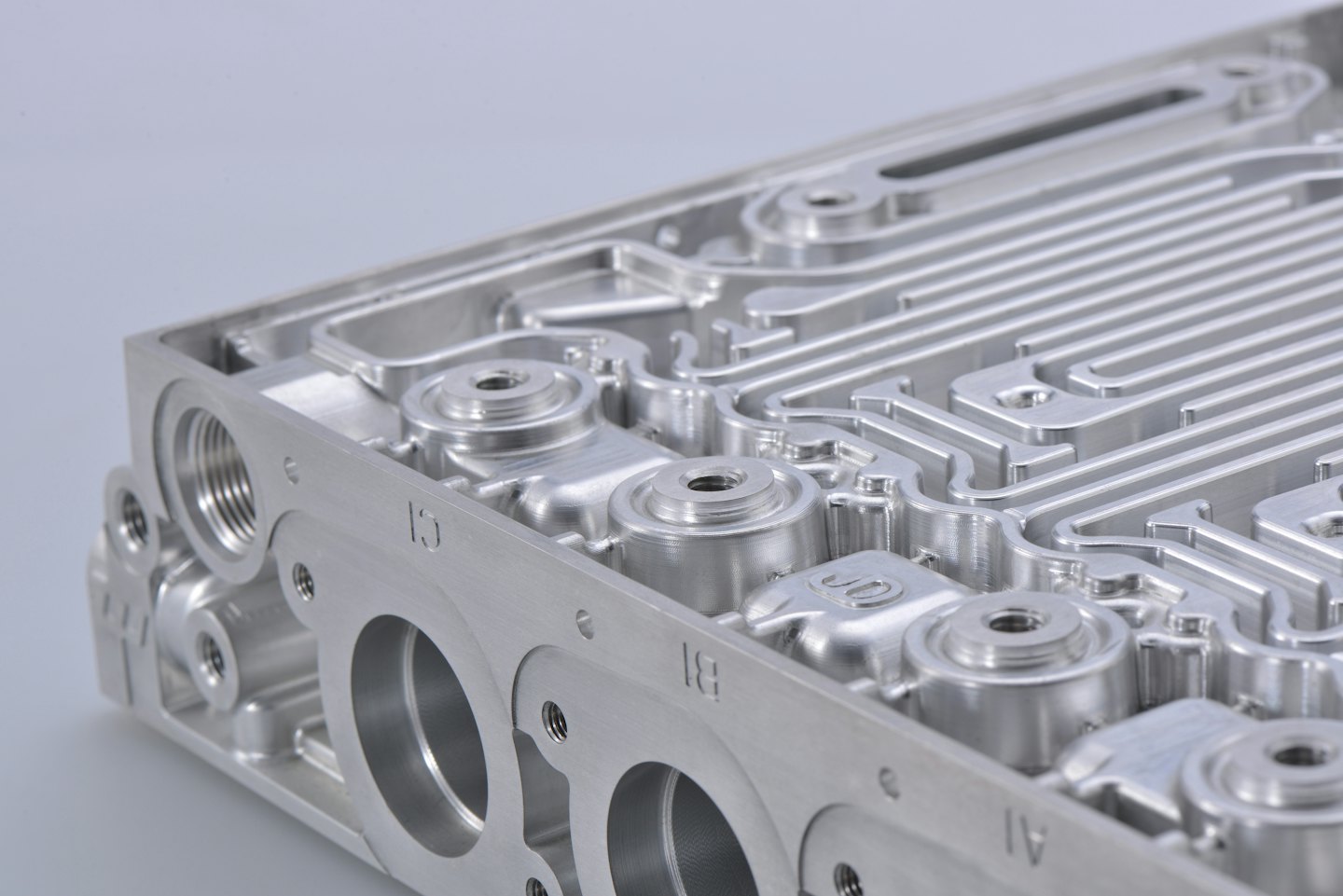 Precision machined aluminum part with internal channels.