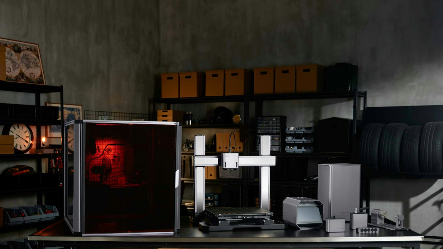 Modern workshop equipped with fabrication machines and metal shelving.