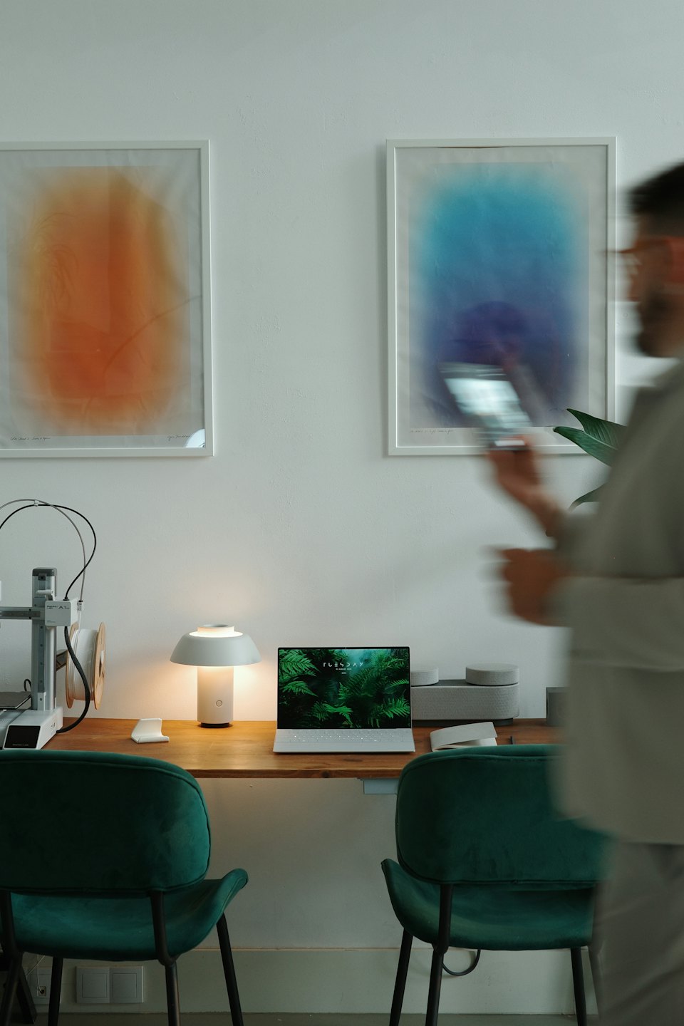 Modern home office with a desk and 3D printer.